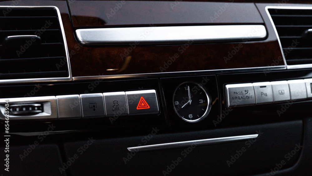 Red emergency button Interior of modern luxury car. Details of automatic transmission gear shift, multimedia control system, car control panel, Air Vent and dashboard inside. Prestige sport automobile