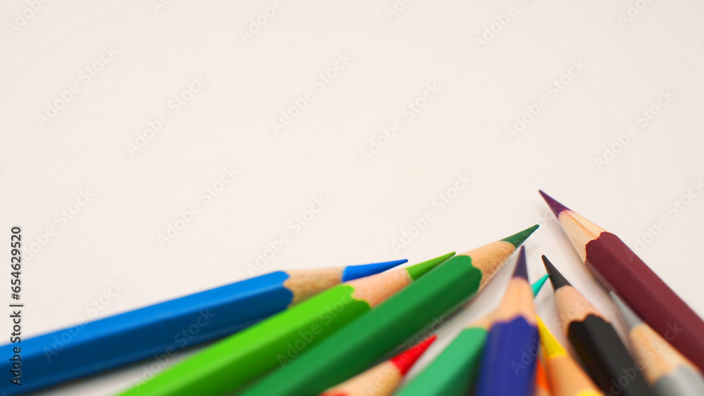 Border of an assortment of colourful pencils on white background Border of an assortment of colourful pencils on white background