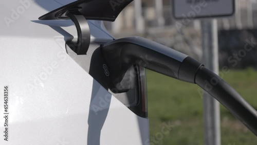Close up: Charging electric vehicle at the supercharger