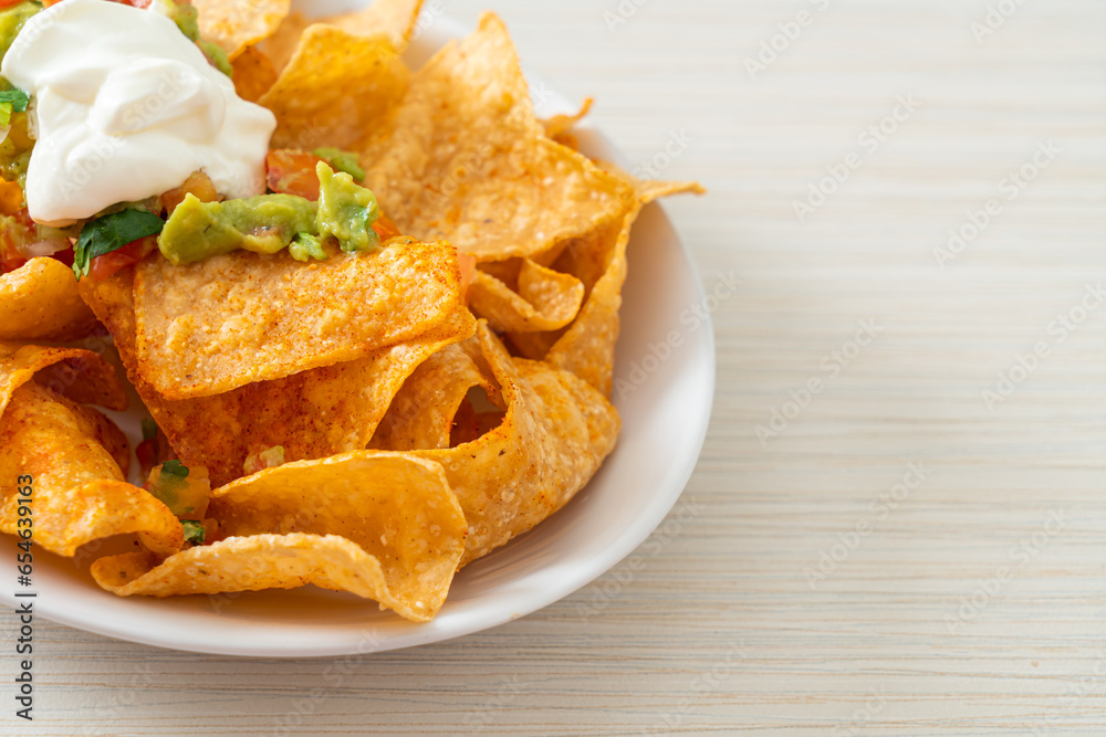 nachos tortilla chips with jalapeno, guacamole, tomatoes salsa and dip nachos tortilla chips with jalapeno, guacamole, tomatoes salsa and dip
