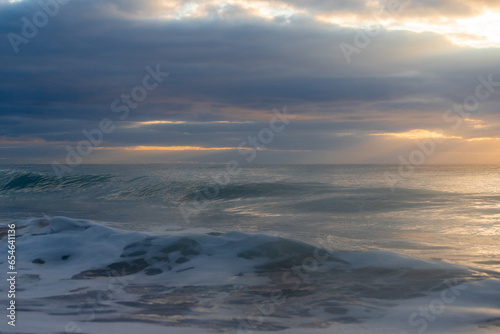 Cloudy sunrise at the beach. © AlexandraDaryl
