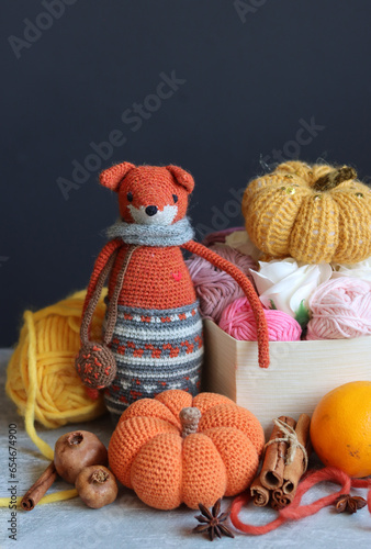 Autumn crocheting ideas. Cute crocheted amigurumi toys, wool yarn, crochet hook. Space for text. 