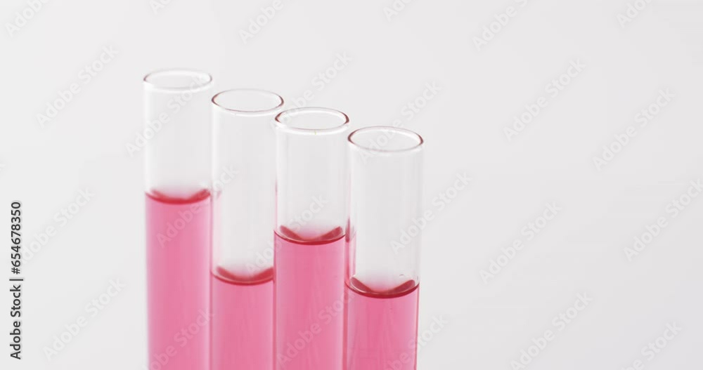 Video of glass laboratory test tubes with red liquid and copy space on white background Video of glass laboratory test tubes with red liquid and copy space on white background
