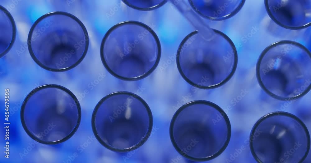 Video of laboratory pipette and test tubes with copy space on blue background Video of laboratory pipette and test tubes with copy space on blue background
