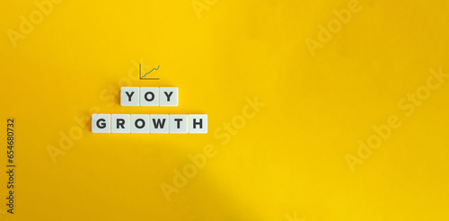 Year Over Year (YOY) Analysis Concept Image. Letter Tiles on Yellow Background. Minimal Aesthetic. photo