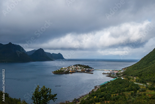 Husoy village on a small island at Senja, Norway. Sun lighting the island.