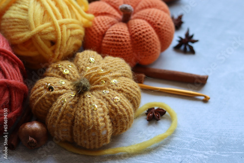 Cozy autumn crochet. Close up photo of handmade amigurumi toys made of natural yarn. Cute decorations for autumn holidays. Hobbies and leisure concept. 