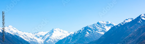 Banner The mountain view of alpine as snow-capped mount peaks in Winter mountains, panorama scene