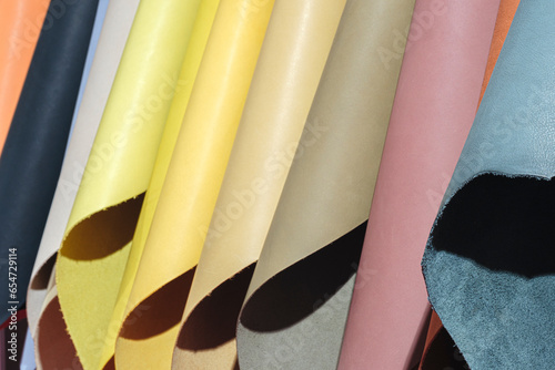 Mix colorful hanging vertical stripe leather on the rack. Texture of multicolored leather close up. photo