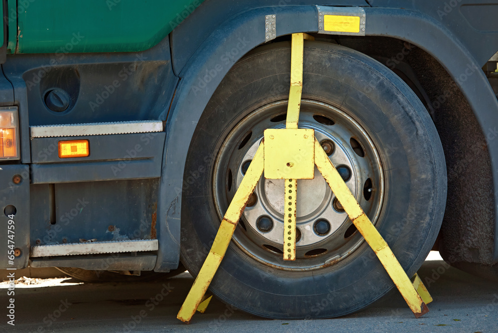 Locked wheel of the truck, parking violation. Wheel clamp placed on