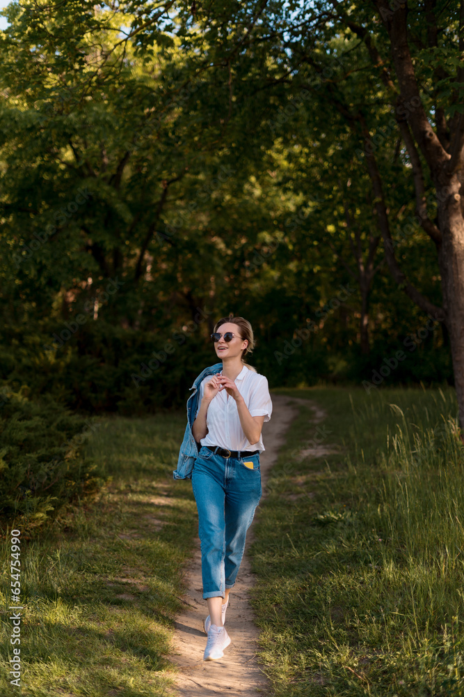 Woman in sunglasses walking in the park
