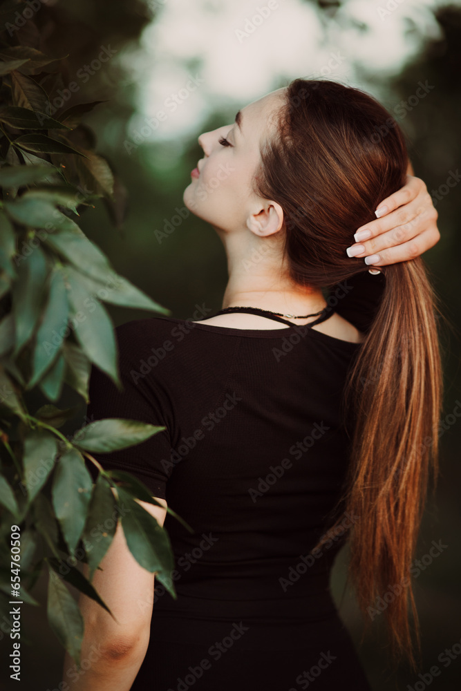 romantic young woman posing in dark green foliage, girl face on summer nature, beauty and fashion concept romantic young woman posing in dark green foliage, girl face on summer nature, beauty and fashion concept
