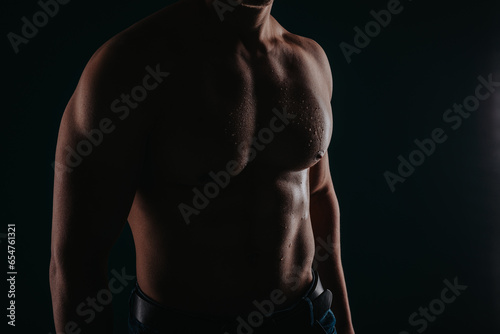 Silhouette photo of sweaty male's torso.