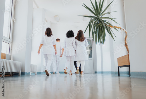 Experienced Female Doctors in Hospital Hallway