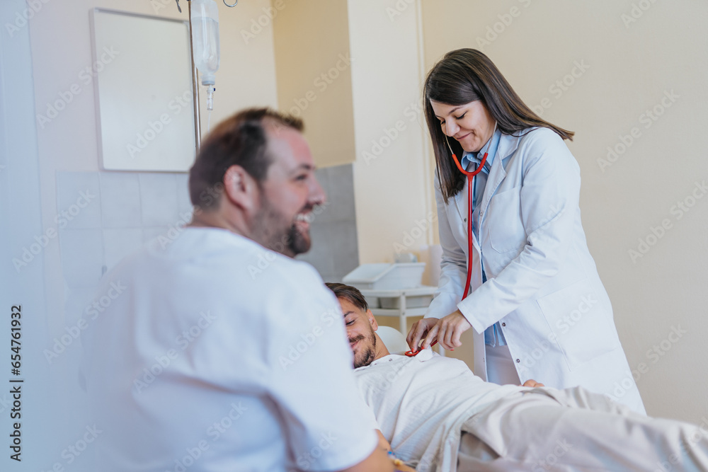 Experienced Doctor Providing Medical Consultation and Infusion Therapy in a Hospital Room Experienced Doctor Providing Medical Consultation and Infusion Therapy in a Hospital Room