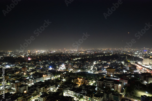 aerial drone tripod shot showing cityscape of jaipur delhi with fireworks  rockets  pyrotechnics and sky lanterns at night in celebration of makar sankranti  independence republic day and diwali in In