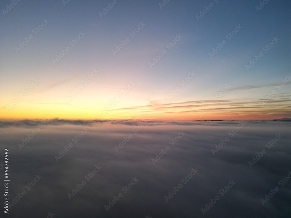 Sunrise above the clouds seen from drone