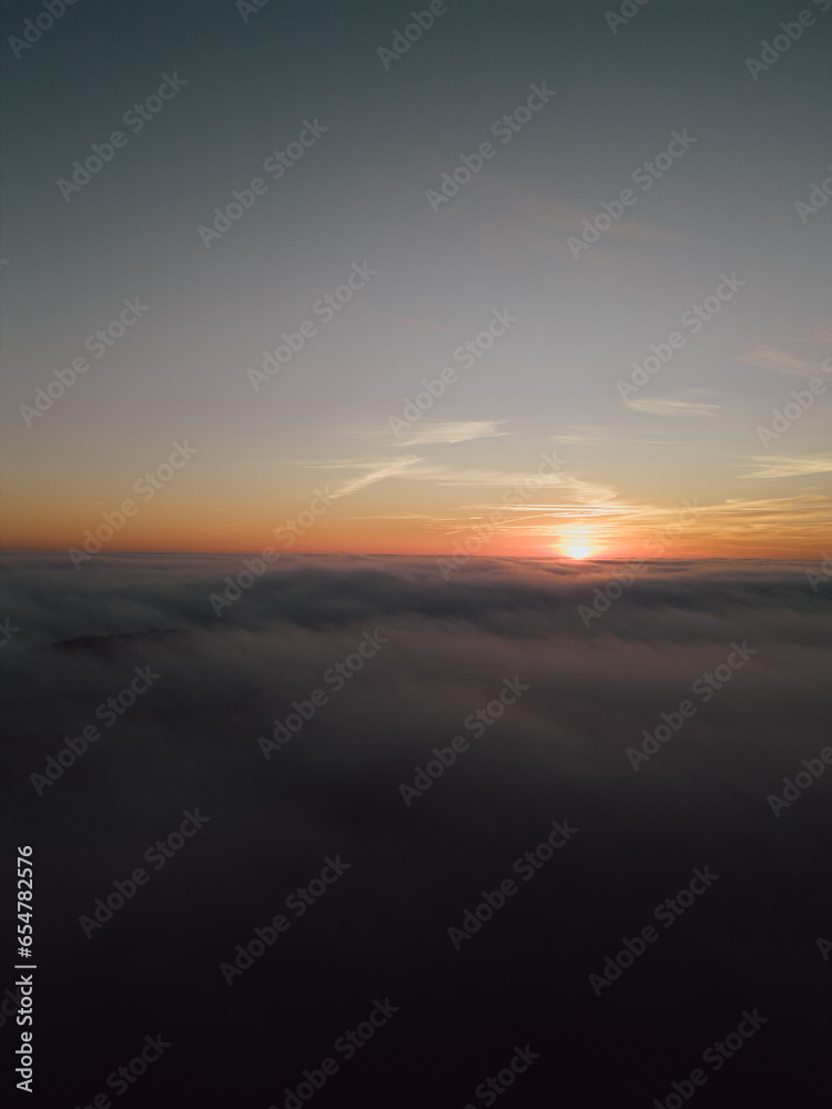 Sunrise above the clouds seen from drone