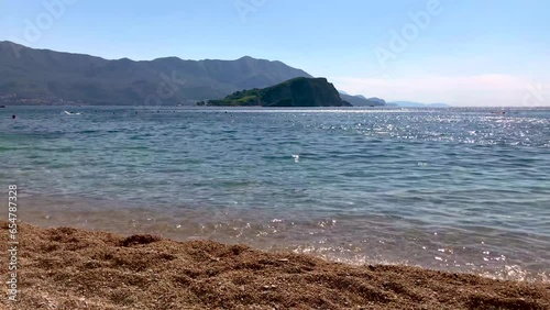 Small Waves at the Beach with an Island in the Background photo