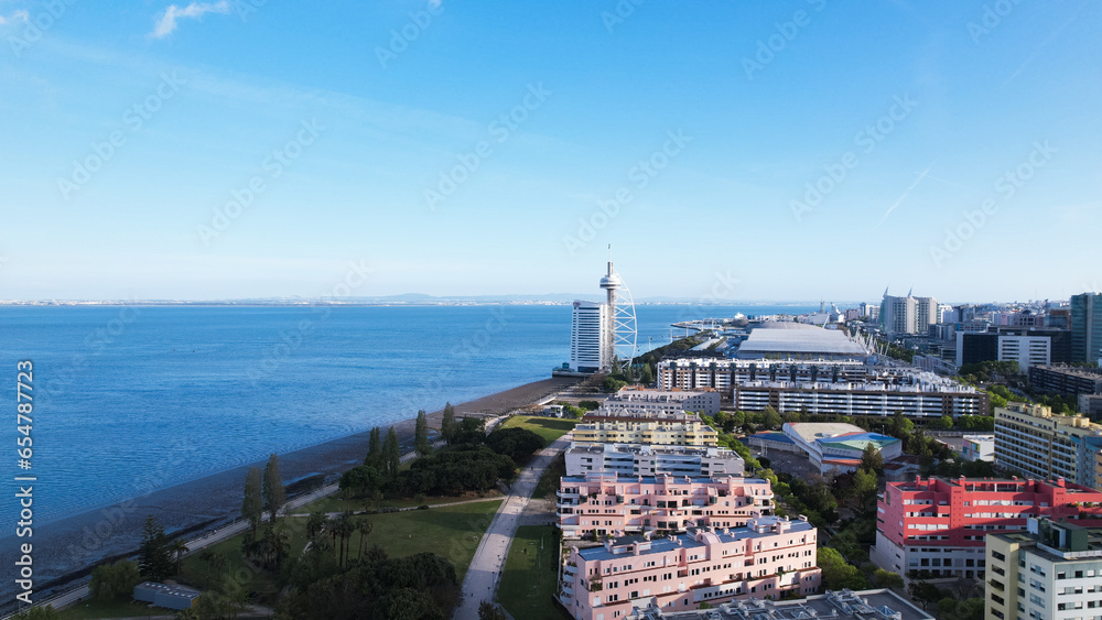 Lisbon, Portugal, April 24, 2022: DRONE AERIAL SHOT - The Vasco da Gama Tower and Myriad Hotel at Park of Nations in Lisbon. Modern residential neighborhood with contemporary architecture.