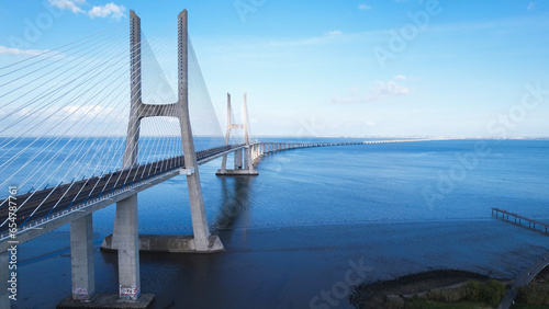 Aerial view of the Vasco da Gama Bridge is a cable-stayed bridge located in the city of Lisbon in Portugal and crosses the Tagus River. It is the second-longest bridge in Europe.