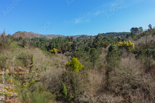 The river hiking trail Ecovia do Vez near Arcos de Valdevez, Portugal. Ecovia do Vez wooden pathways along the riverside. photo