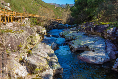 The river hiking trail Ecovia do Vez near Arcos de Valdevez, Portugal. Ecovia do Vez wooden pathways along the riverside. photo