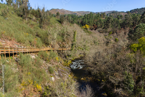 The river hiking trail Ecovia do Vez near Arcos de Valdevez, Portugal. Ecovia do Vez wooden pathways along the riverside. photo