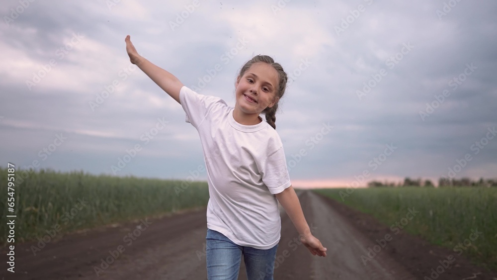 girl child running in nature in the park. happy family kid dream concept. free child daughter runs along a rural road next to a field in nature. free girl runs lifestyle and plays in the park girl child running in nature in the park. happy family kid dream concept. free child daughter runs along a rural road next to a field in nature. free girl runs lifestyle and plays in the park