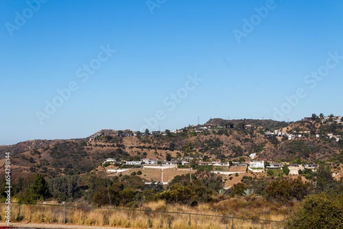 Residential Area near the Hollywood Reservoir. Hollywood Hills looking down on some beautiful houses on the opposite hillside in Los Angeles, California in the summer.