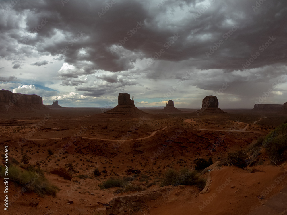 The Monument Valley Navajo Tribal Park in Arizona, USA. View of the West Mitten Butte, East Mitten Butte, and Merrick Butte Monuments during a storm.