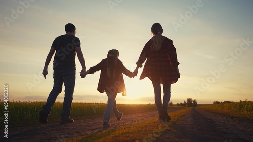 happy family in the park at sunset. people group father and daughters walking in nature at sunset in the park. friendly lifestyle family kid dream concept. fathers day concept