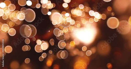 Abstract motion background with glittering gold bokeh.