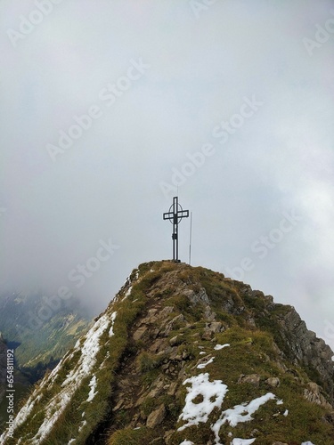 Summit cross on the Druesberg in the Hoch-Ybrig area. Autumn hike with the first snow. Schwyz Oberiberg Switzerland. High quality photo