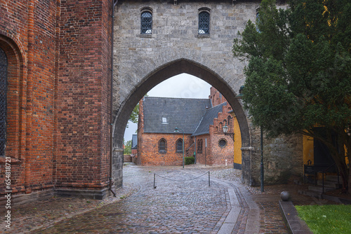 The Absalon Arch  between bishop's palace and Gothic Roskilde Cathedral. Roskilde. Denmark photo