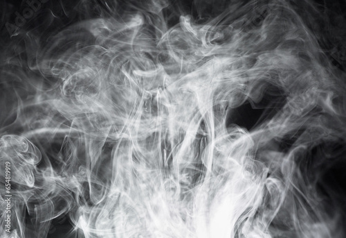 Smoke, steam or gas in a studio with dark background by mockup space for magic effect with abstract. Incense, fog or vapor mist moving in air for cloud smog pattern by black backdrop with mock up