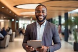 portrait african american businessman using digital tablet in hotel or office