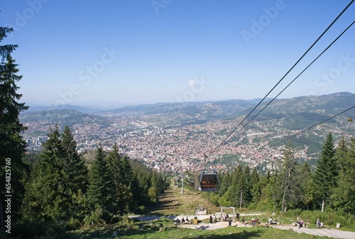 Sarajevo, Bosnia and Herzegovina - Sep 28, 2023: Distant view of Sarajevo city in Bosnia and Herzegovina federation from the surrounding viewpoints in a sunny summer afternoon. Selective focus. photo