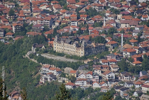 Sarajevo, Bosnia and Herzegovina - Sep 28, 2023: Distant view of Sarajevo city in Bosnia and Herzegovina federation from the surrounding viewpoints in a sunny summer afternoon. Selective focus.