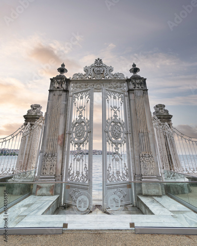Photography Pair of elaborately decorated white painted metal gates leading to the opulent D