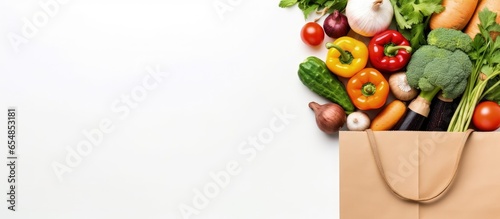 Top view of a white background with a paper bag containing various healthy food