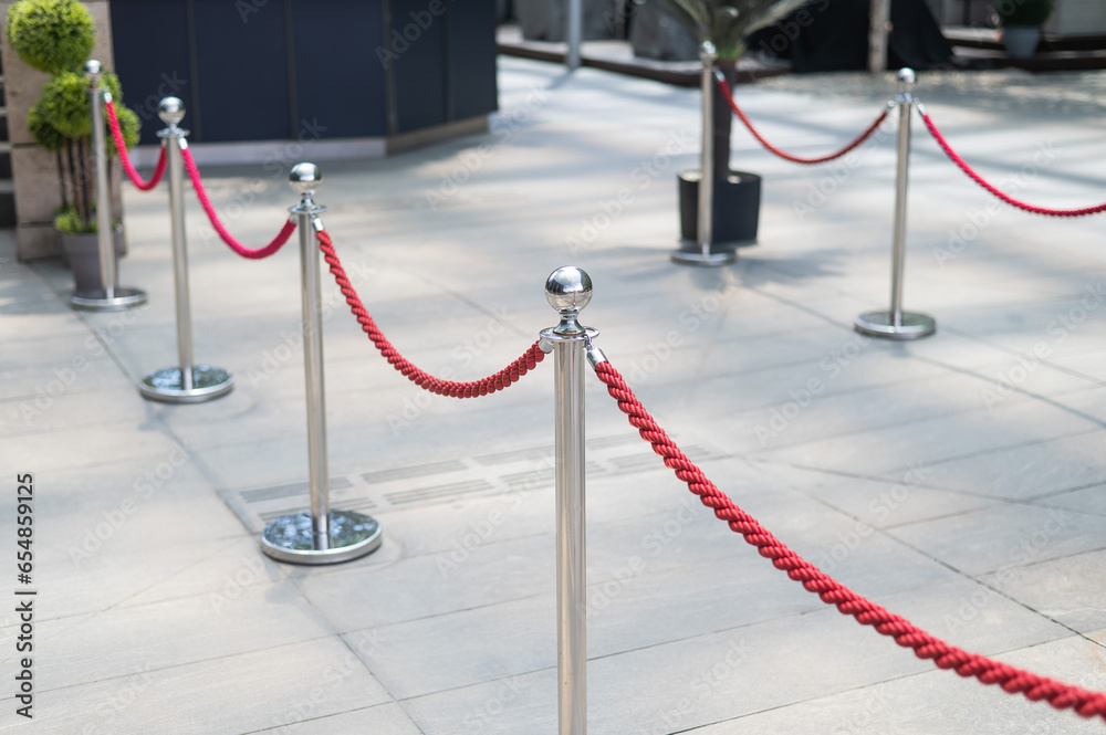 Naklejka premium Fence posts with red rope. 