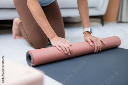  Woman roll her yoga mat after class