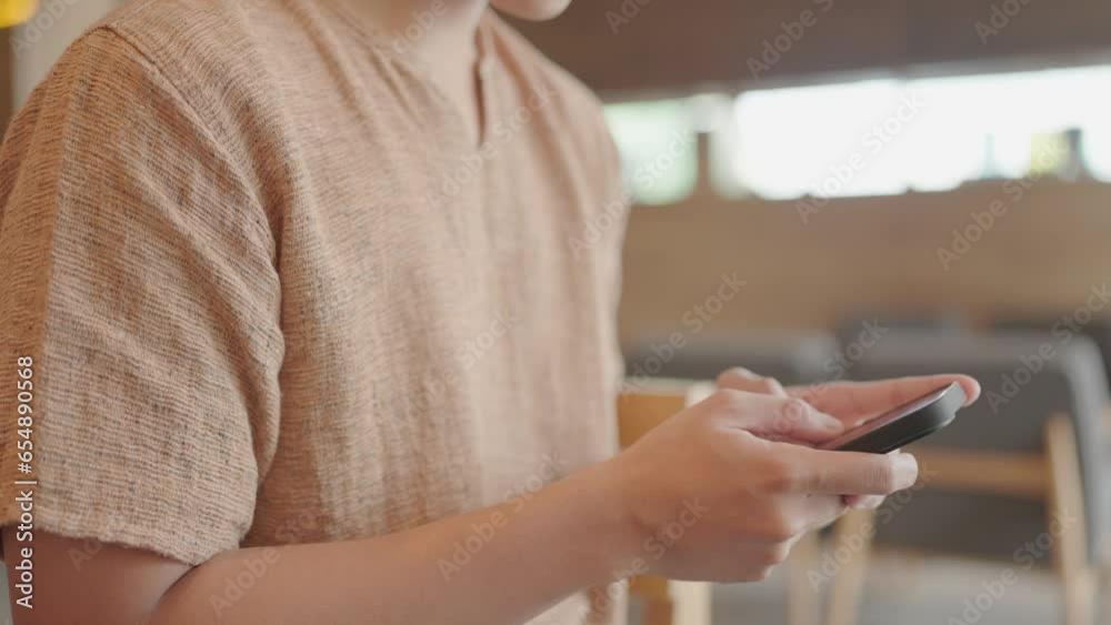 Close-up of a man sitting typing messages on a smartphone and surfing the internet. Close-up of a man sitting typing messages on a smartphone and surfing the internet.