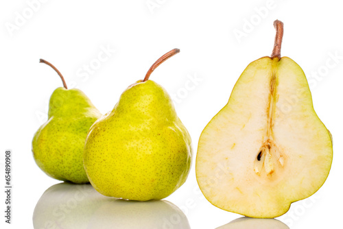One half of a ripe pear and two whole pears, macro, isolated on white background.