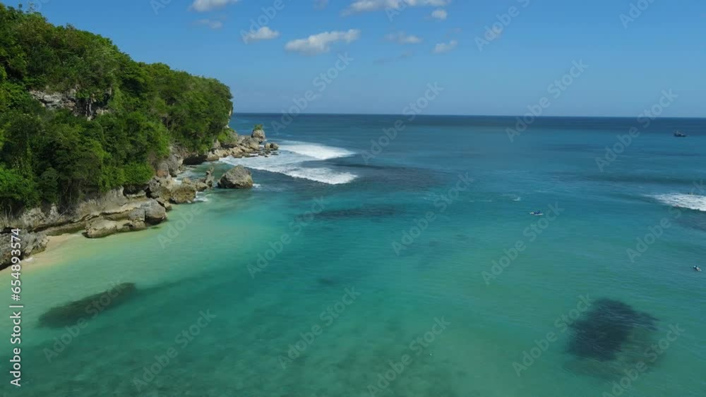 Padang Padang surf spot in Bali and turquoise ocean with waves. Aerial view Padang Padang surf spot in Bali and turquoise ocean with waves. Aerial view