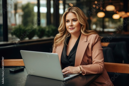 a 35 years old plus size manager using laptop computer on the go