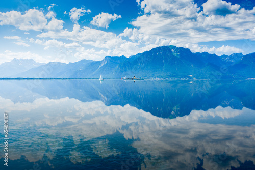 Wallpaper Mural Cloudy sky and mountains reflected in Geneva lake, Switzerland Torontodigital.ca