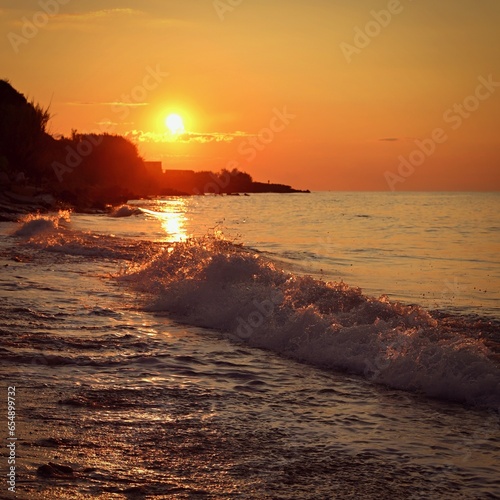 Beautiful sunset on the beach with the sea. Greece - island of Corfu  Kerkyra . Concept for travel  holidays and summer vacations.