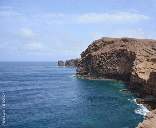 Coast with cliffs, calm sea and sky with clouds, Galdar, Gran Canaria, Spain photo